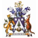 A shield with two stars shine upon a central Norfolk pine tree. It is supported by a lion and a kangaroo. Above is a crest of silver and blue on top of which is a lion holding a cup.